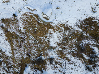 Isolated church in snowy mountain landscape. Italian Alps. Aerial drone shot