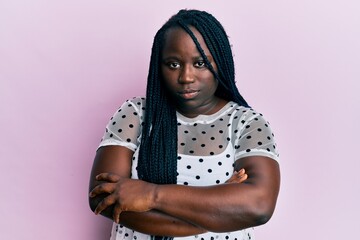 Young black woman with braids wearing casual clothes skeptic and nervous, disapproving expression...