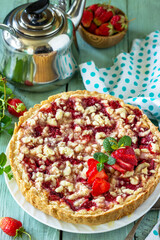 Homemade baking. Summer dessert. Strawberry pie with crumbs and fresh strawberries on a wooden rustic table.