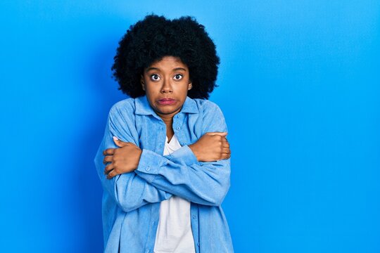 Young african american woman wearing casual clothes shaking and freezing for winter cold with sad and shock expression on face