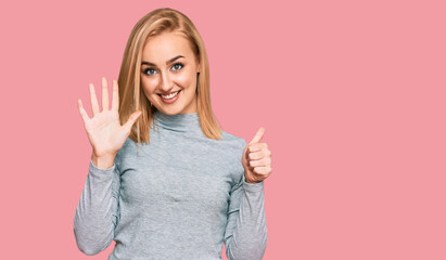 Beautiful caucasian woman wearing casual clothes showing and pointing up with fingers number six while smiling confident and happy.