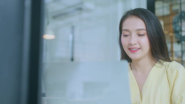 young attractive asian female wear casual cloth hand use smartphone and laptop device comminication social contact in cafe restaruant sit at counter next to big window daylight