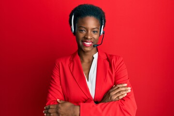 Young african american girl wearing call center agent headset happy face smiling with crossed arms...