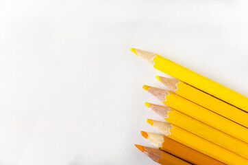 yellow pencils on white background
