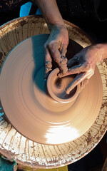 potter's wheel and hands