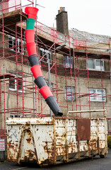 House renovation work with skip and rubbish chute