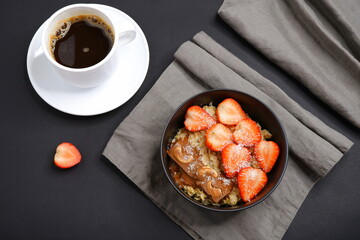 Oatmeal with strawberries and coffee. Cooking. Food.