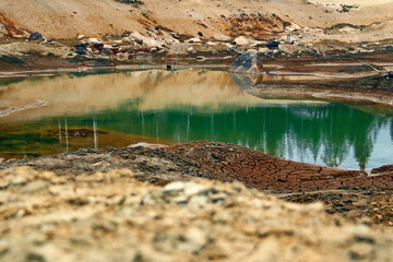 Fototapeta na wymiar Dirty bottom of a dried-up lake. Ecological problems.