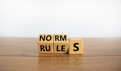 Rules or norms symbol. Turned cubes and changed the word 'norms' to 'rules'. Beautiful wooden table, white background, copy space. Business and rules or norms concept. - obrazy, fototapety, plakaty