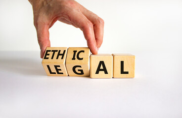 Ethical or legal symbol. Businessman turns wooden cubes and changes the word 'legal' to 'ethical' on a beautiful white table, white background. Business and ethical or legal concept. Copy space. - obrazy, fototapety, plakaty