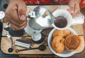 Coffee making with Moka pot and snack.