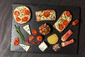 Healthy food rye bread with cream cheese and tomato. Sliced tomatoes with bread. Baked garlic with cheese and ham.