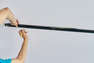 Installation of LED ceiling mounted modern track downlight.