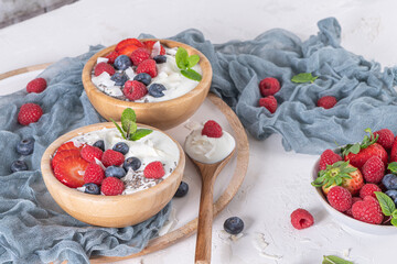 Yogurt and berries for healthy breakfast. Bowl of greek yogurt with raspberry, blueberries and strawberries