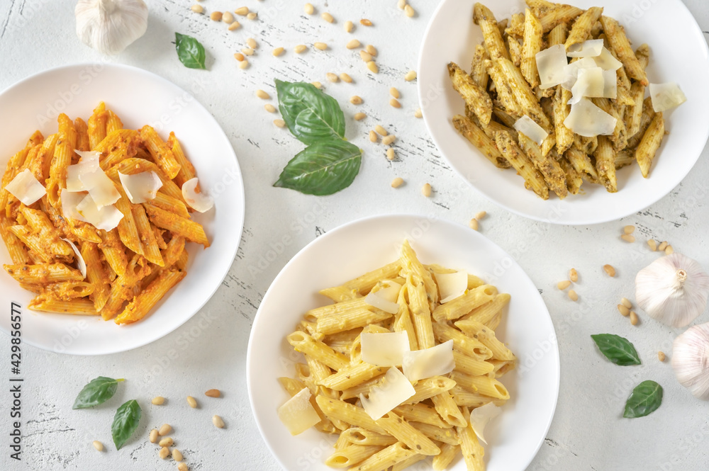 Poster penne pasta with various pesto sauces