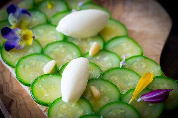 Fototapeta na wymiar sliced cucumbers toast appetizer with pine nuts