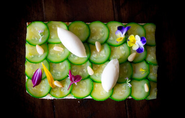 sliced cucumbers toast appetizer with pine nuts