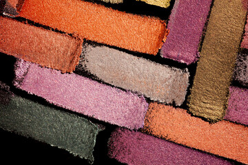 Eye shadow multi colored brown smudge loose black background