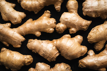 Organic ginger roots for immune boosting on an isolated on a black background, top down view and...