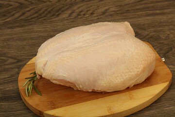 Raw whole chicken breast with skin