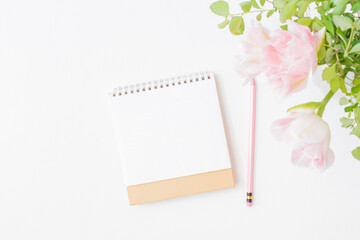 Mockup calendar and pink tulips in a vase on a light background