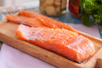 fillet of red fish on a wooden board