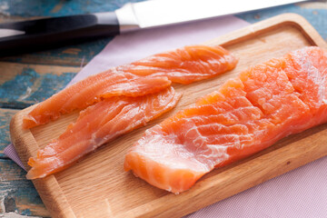 fillet of red fish on a wooden board
