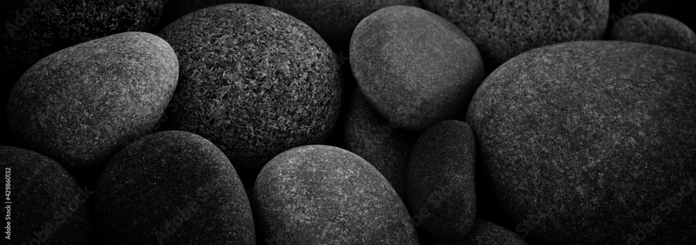 Aufkleber dark black abstract smooth round pebbles texture background