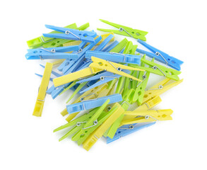 Colorful plastic clothespins on white background, top view