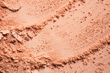 Cosmetic powder or blush bronzer texture background red brown nude smudge