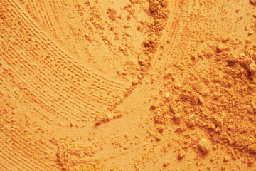 Cosmetic powder or blush bronzer texture background red brown nude smudge