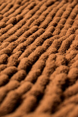 Close up of brown and soft rug texture with line pattern 