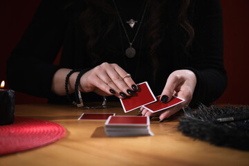 Soothsayer predicting future with cards at table indoors, closeup
