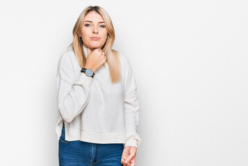 Young caucasian woman wearing casual winter sweater touching painful neck, sore throat for flu, clod and infection