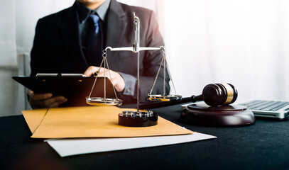 Business and lawyers discussing contract papers with brass scale on desk in office. Law, legal...