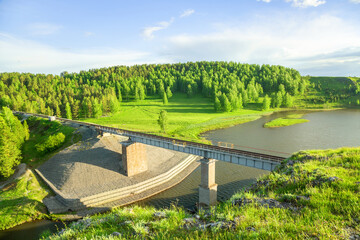 Aerial view of the road on the bridge without moving cars over the river, top view.