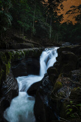 Naklejka premium Cascada capturada en la noche bajo un cielo de un hermoso color