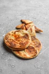 Fresh pita on a stone table.. Still life of food. Georgian cuisine. Spanish food. National cuisine.