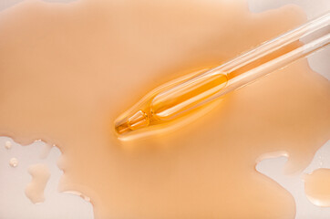 Liquid pipette orange green gel or serum glass of microscope background