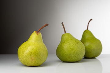 Pear, pakkham varieties, on a light background, with reflection