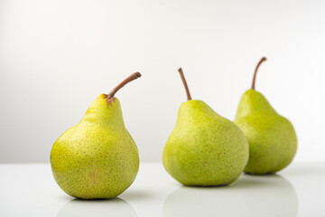 Pear, pakkham varieties, on a light background, with reflection