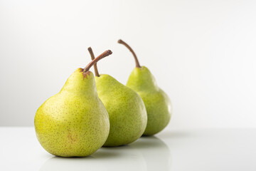 Pear, pakkham varieties, on a light background, with reflection