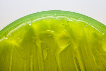Cream gel green transparent cosmetic sample texture with bubbles background