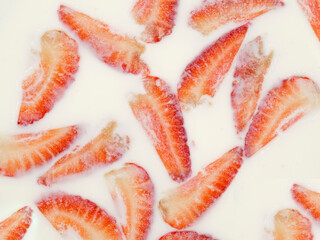 Strawberry slices in milk. The concept of a simple summer rustic dessert. Not a studio lifestyle photo.