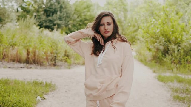 Beautiful girl in a hoodie and sweatpants in nature.