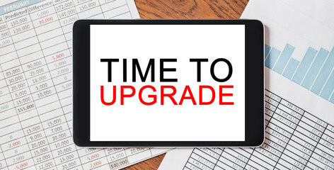 Tablet with text Time to upgrade on your desktop with documents, reports and graphs. Business and...