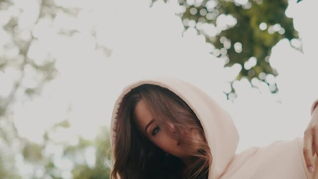Beautiful girl in a hoodie and sweatpants in nature.