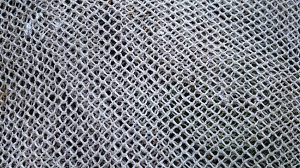 knitted texture of fabric with a mesh pattern as background or as wallpaper