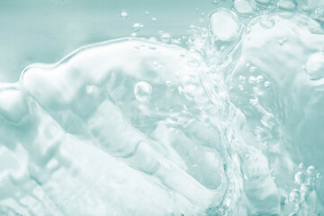 Blue green splashing cosmetic moisturizer, micellar water,  toner, or emulsion abstract background....
