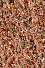 Brown stucco wall with green and brown glass for background